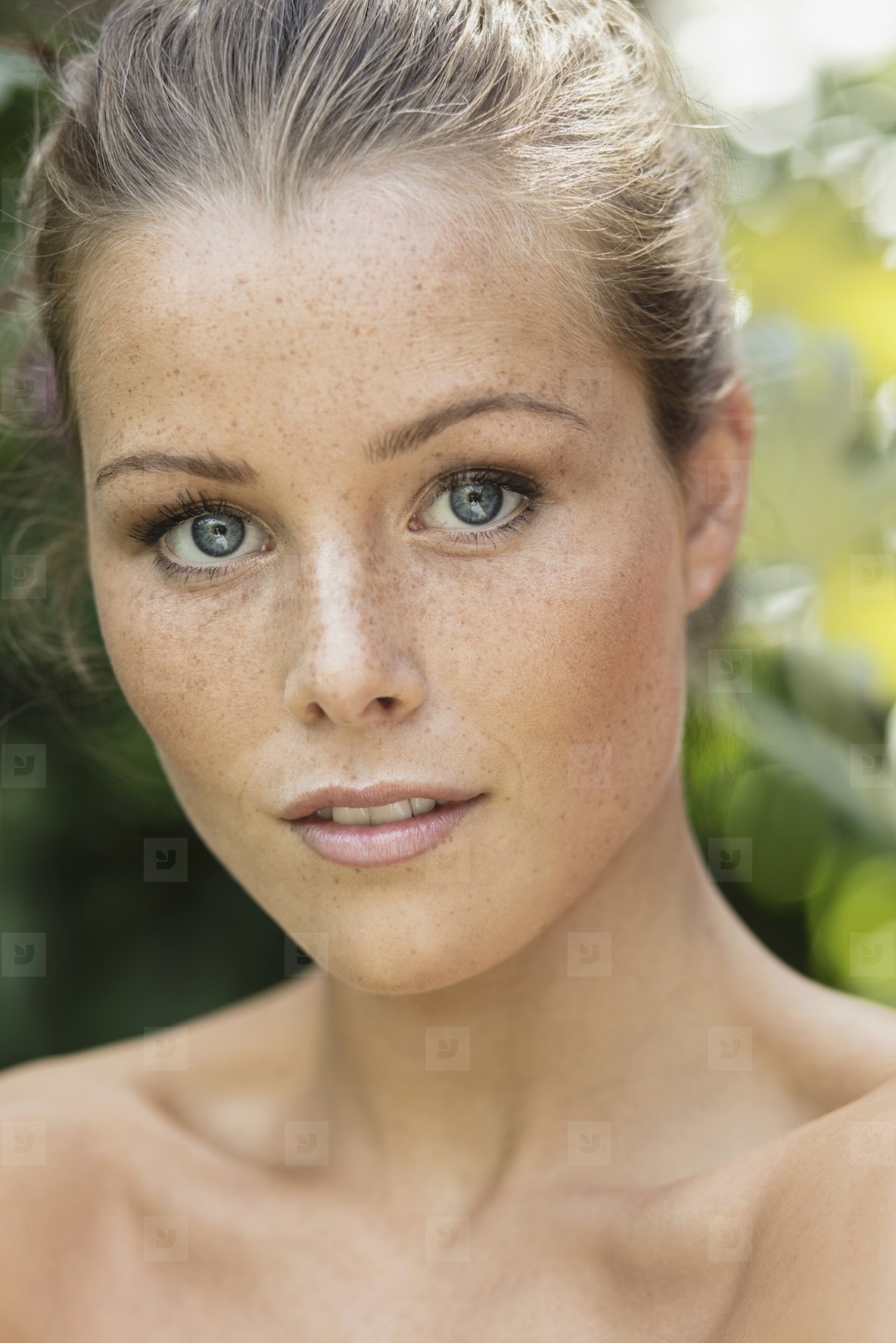 Close up portrait of beautiful young woman with bare shoulders