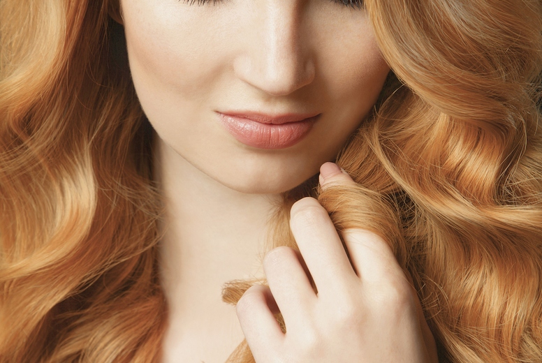 Close up portrait of beautiful young woman with hand in long