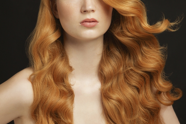 Studio portrait of beautiful young woman with wav