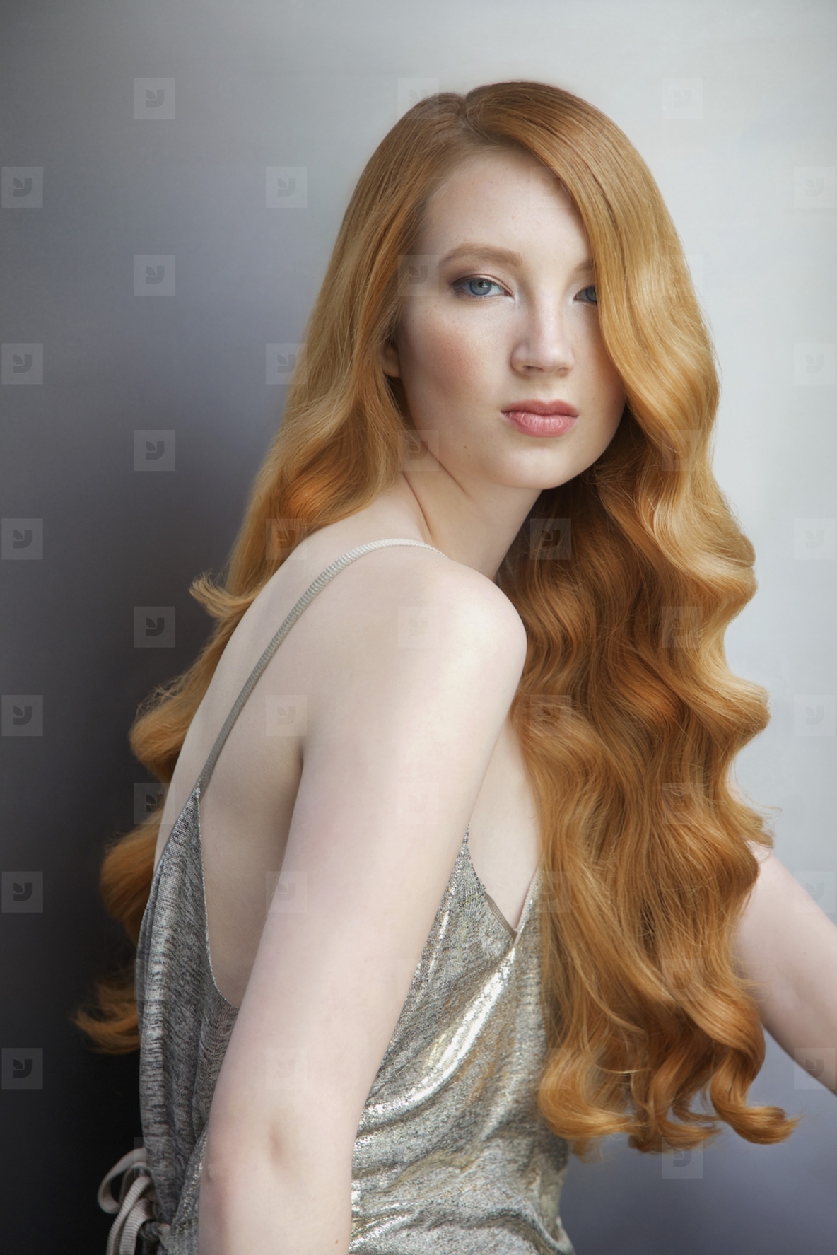 Studio portrait of beautiful young woman with curly