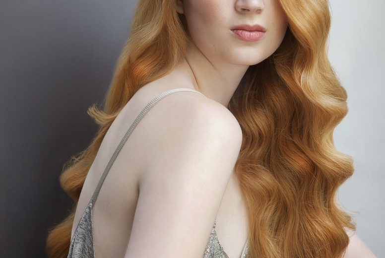 Studio portrait of beautiful young woman with curly