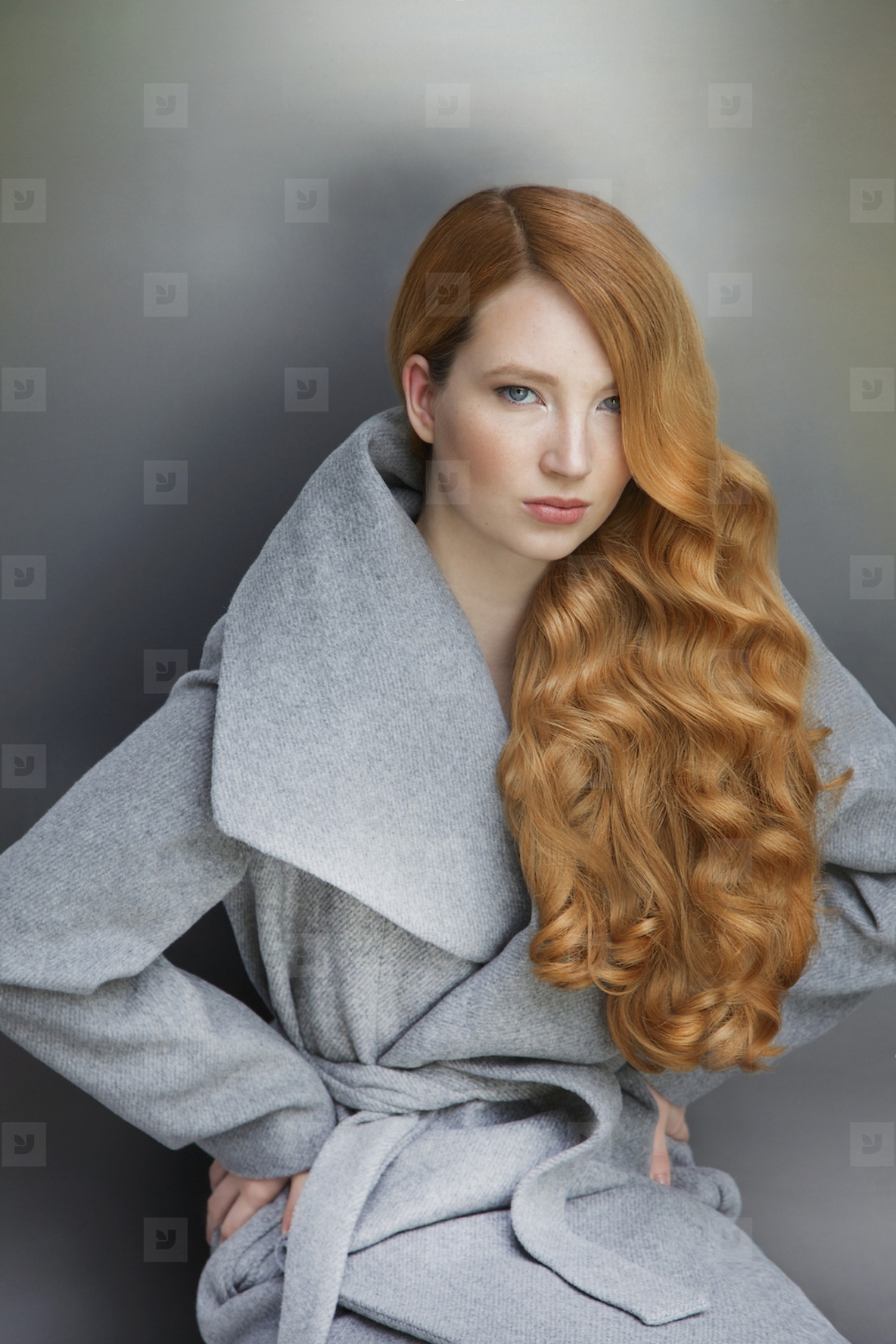 Studio portrait of beautiful stylish young woman with long