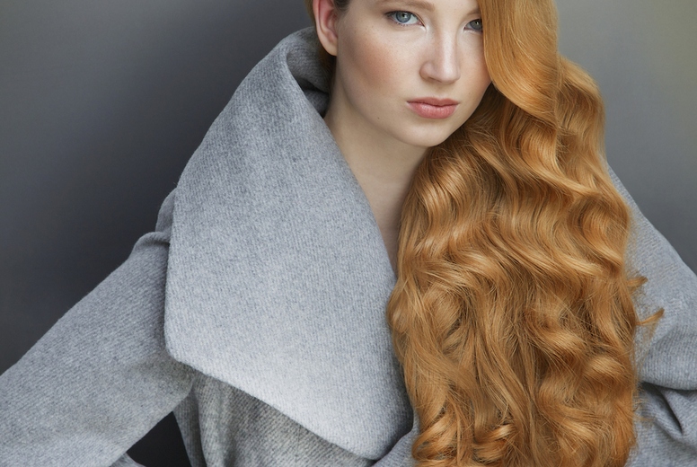 Studio portrait of beautiful stylish young woman with long