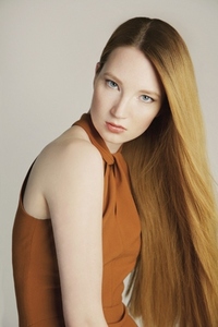 Studio portrait of beautiful serious young woman with long