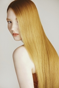 Portrait of beautiful woman looking at camera with long sleek red hair partially obscuring her face