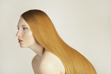 Side view portrait of beautiful serene young woman with long