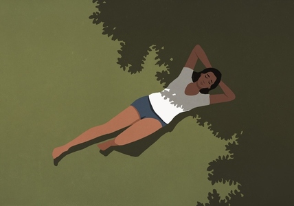 View from above of serene woman in shorts and t shirt laying in sunlight and shadow in summer grass