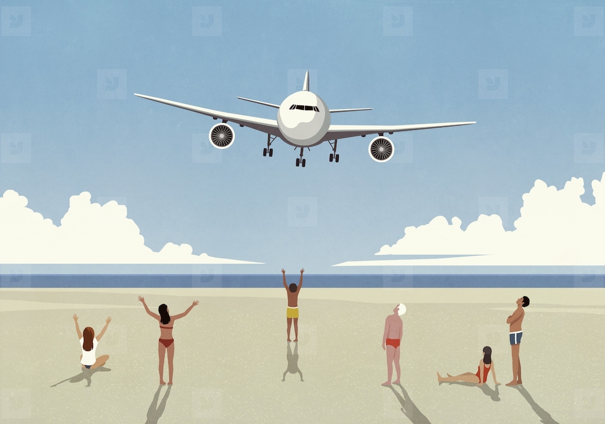 Tourists on sunny summer ocean beach waving at low flying airplane