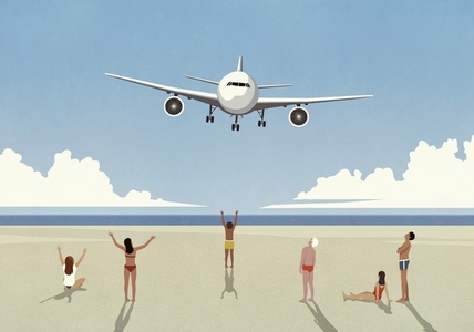 Tourists on sunny summer ocean beach waving at low flying airplane