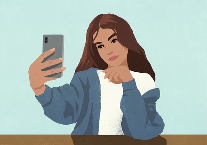Young brunette woman taking selfie with smart phone against blue background