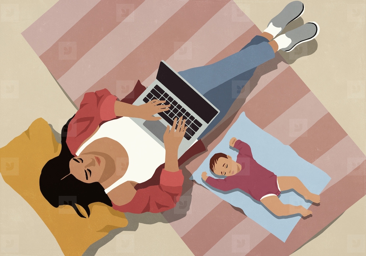 View from above of baby sleeping on floor next to mother working at laptop