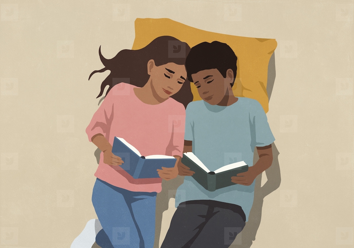 View from above of affectionate mother and son reading books on pillow