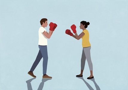 Couple in fighting stance face to face against blue background