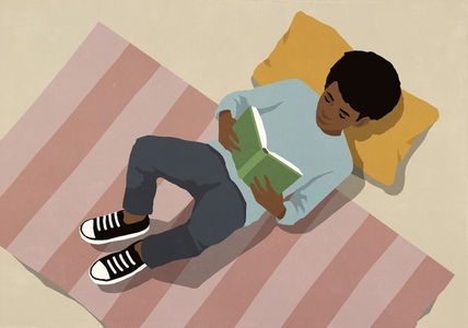 View from above of boy reading book