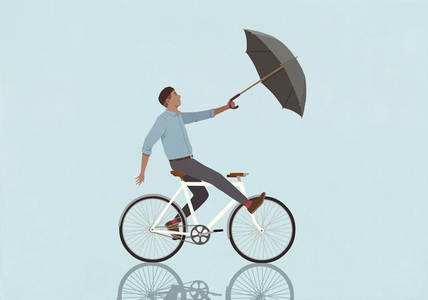 Wind pulling surprised man with umbrella riding bicycle on blue background