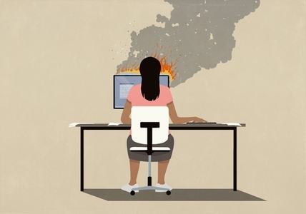 Woman sitting at desk working at computer on fire