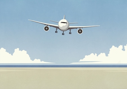 Airplane flying low over sunny summer ocean beach