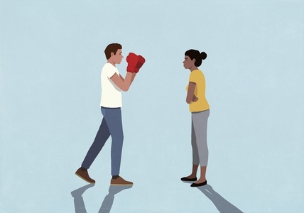 Man in boxing gloves standing in fighting stance face to face with wife on blue background