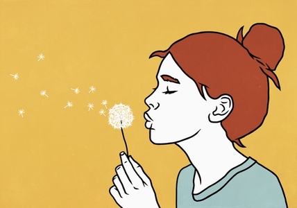 Young redhead woman making a wish blowing dandelion against yellow background