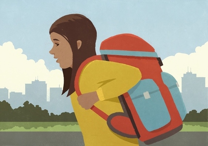 Side view of school girl with large backpack walking in city