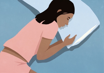 View from above of woman in pink pajamas sleeping on pillow in bed at night