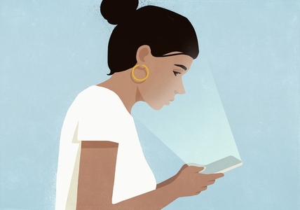 Light from digital tablet glowing in face of woman against blue background