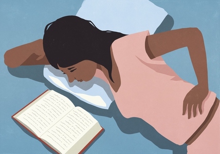 View from above of woman in pajamas relaxing in bed