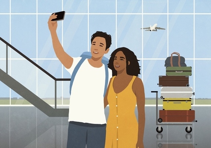 Happy young couple taking selfie in front of stacked luggage in airport concourse