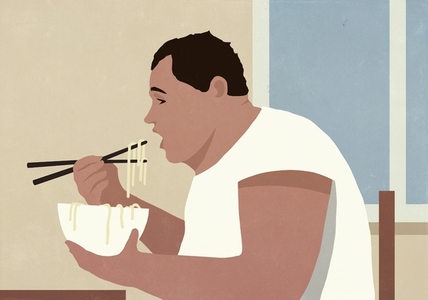 Overweight man eating noodles from bowl with chopsticks by window at home