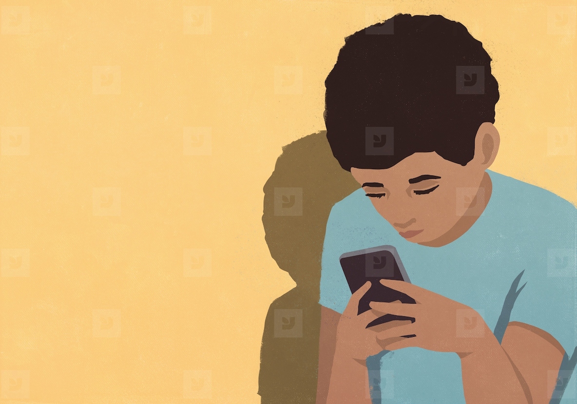 Focused boy using smart phone against yellow background