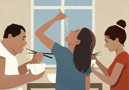 Family eating noodles with fork and chopsticks at dining table