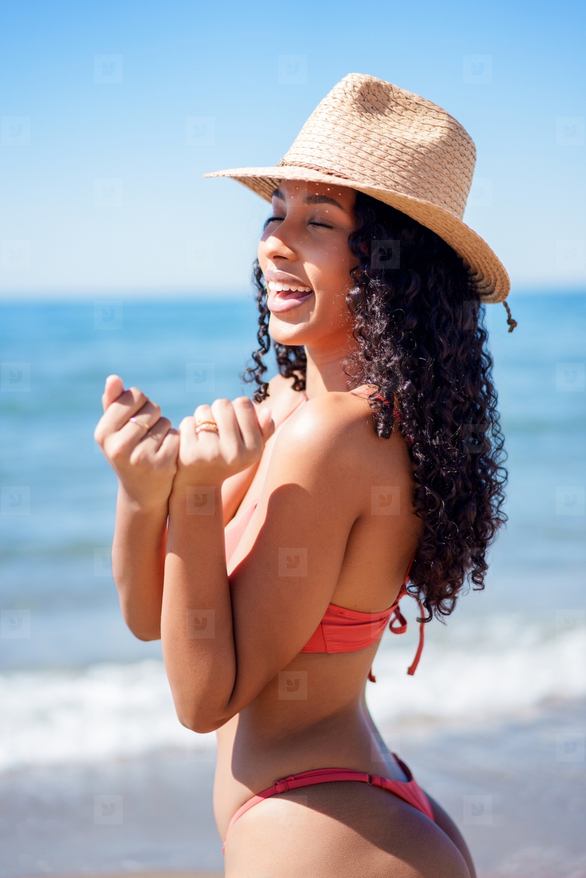 A Joyful Beach Day while wearing a Stylish Straw Hat and a cute Bikini this summer