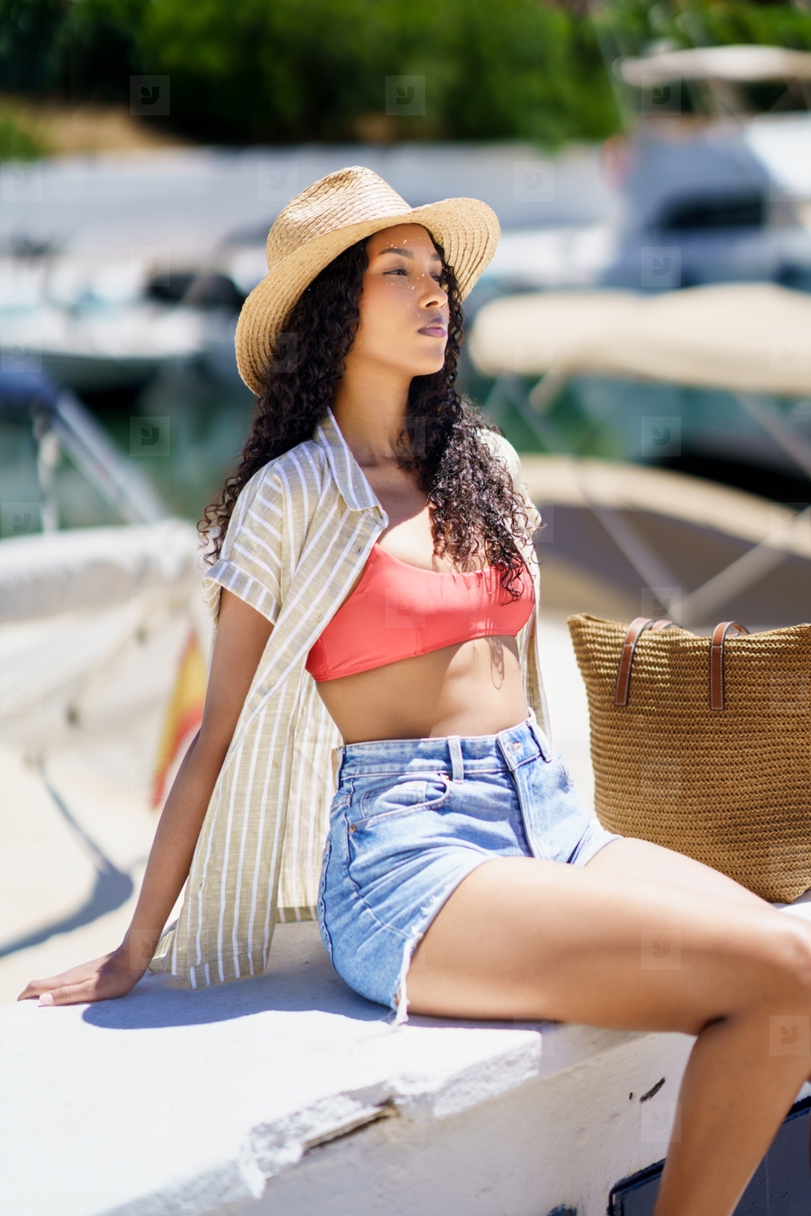 Summer Vibes A Young Woman Dressed in Trendy and Stylish Swimwear at a Beautiful Marina