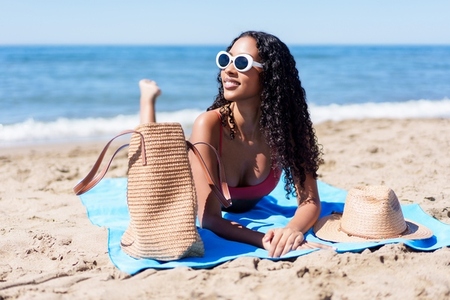 SunKissed Beauty Enjoying Relaxation on the Sandy Beach Under the Bright Sunshine