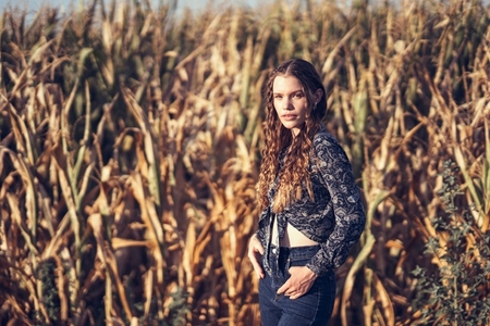 A Young Woman Posing Gracefully in a Calm and Serene Cornfield Surrounded by Beauty A Young Woman Posing Gracefully in a Calm and Serene Cornfield Surrounded by Beauty