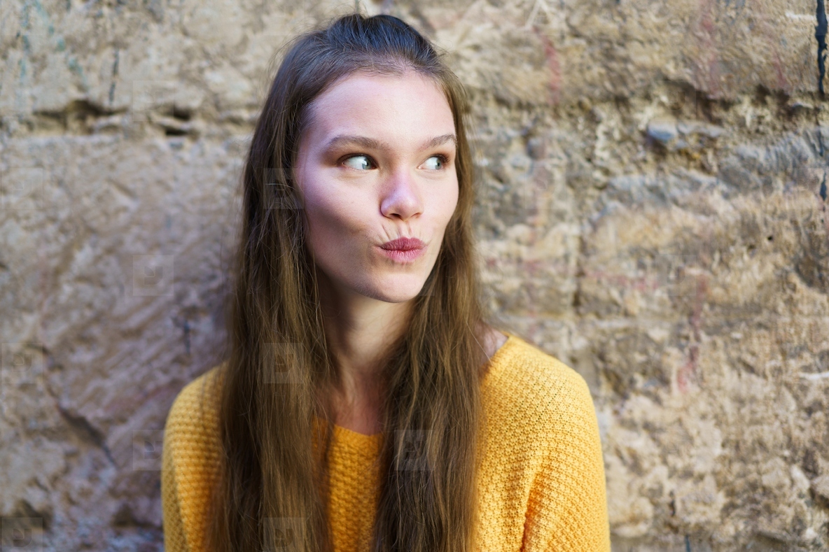 A candid portrait of a young woman in a cozy yellow sweater  embodying warmth and style