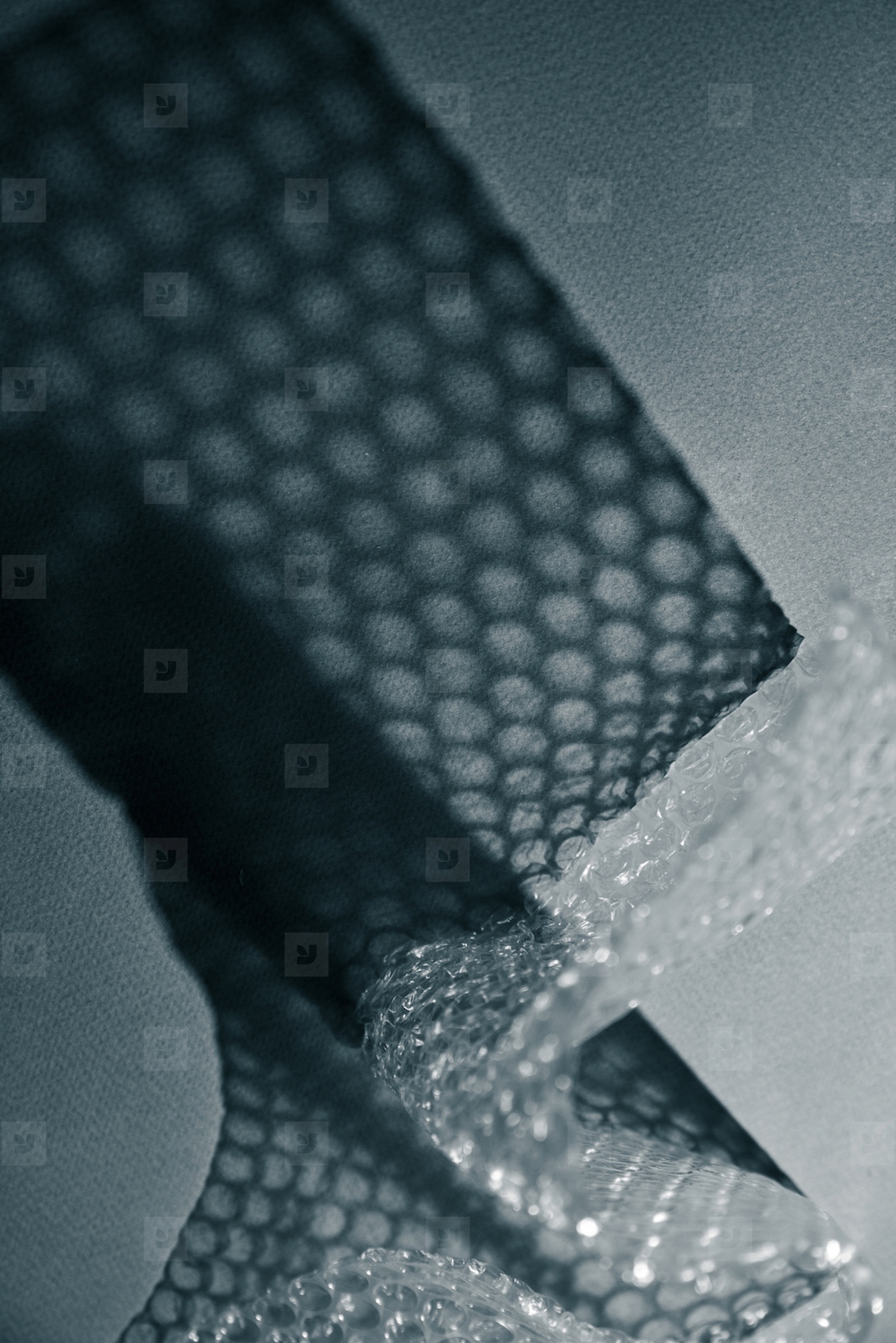 Close up of bubble wrap casting geometric shadows on a surface Abstract minimal texture in monochrome light