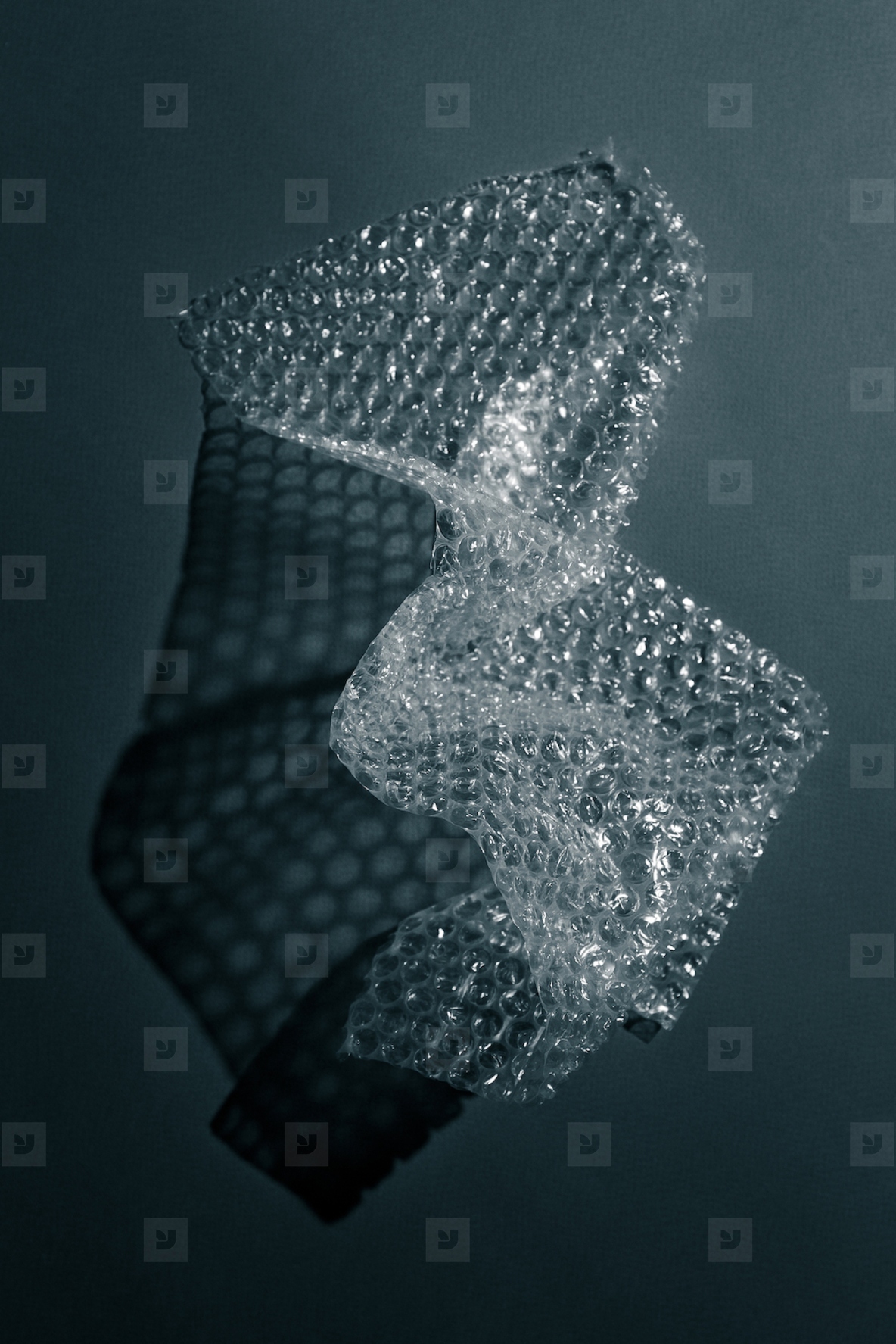 Close up of bubble wrap casting geometric shadows on a surface  Abstract minimal texture in monochrome light