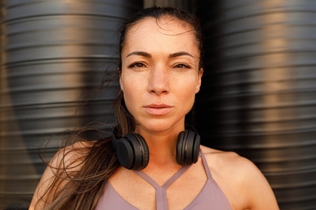 Close up high detail portrait of a young sportswoman at sunset