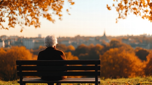 Senior woman sitting on park bench autumn cityscape peaceful thoughtful golden hour