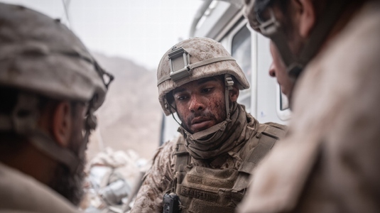 Military medical team treating wounded soldier  battlefield  teamwork  urgent  dusty environment