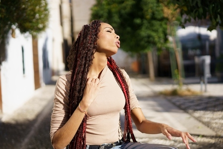A Selfassured Young Woman Conveying Deep Emotion in a Vibrant Urban Environment