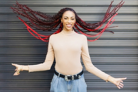 A Vibrant Woman with Beautifully Braided Hair Posing Gracefully Against a Stylish Background A Vibrant Woman with Beautifully Braided Hair Posing Gracefully Against a Stylish Background