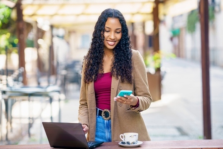 Young Professional Woman Working Remotely in a Caf