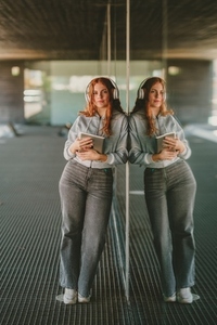 A Young Woman Wearing Headphones in a Contemporary and Modern Living Space Environment A Young Woman Wearing Headphones in a Contemporary and Modern Living Space Environment