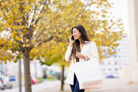A Stylish Woman Enjoys Shopping in Trendy Fall Fashion and Accessories in Autumn Colors A Stylish Woman Enjoys Shopping in Trendy Fall Fashion and Accessories in Autumn Colors