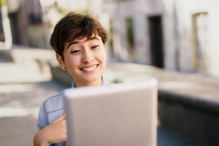 Joyful Interaction A Group of Smiling Young People Happily Engaged in a Video Call Outdoors