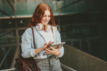 A Young Woman Relishing Music and Engaging with Technology in a Lively Urban Environment