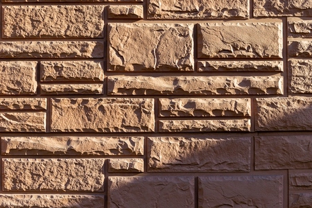 Close up of a decorative stone brick wall with textured surface and natural patterns
