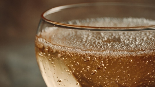 Close up champagne glass golden bubble drink celebration festive sparkling beverage